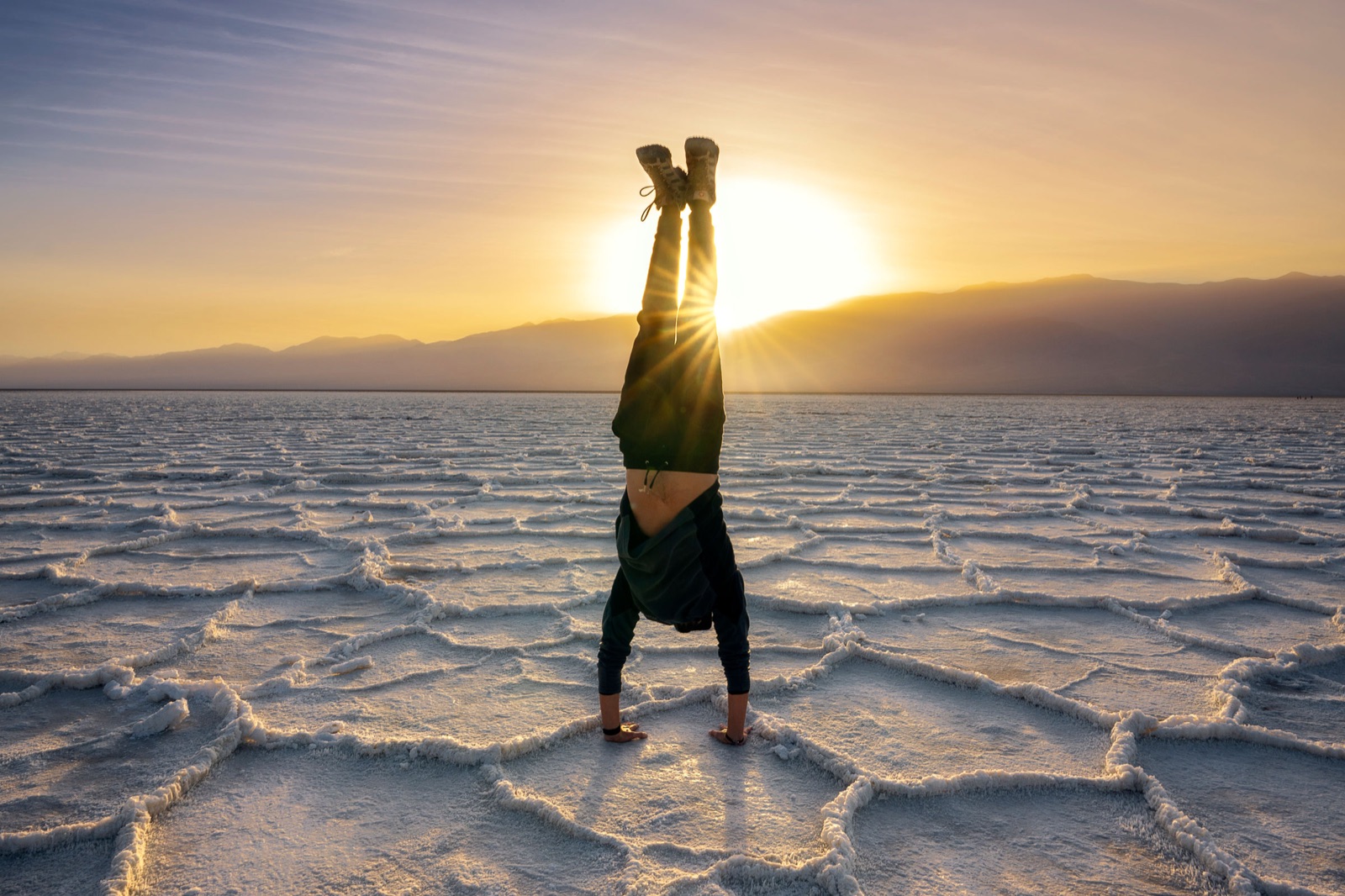 Yaniv Bekerman doing a handstand on the salt flats at sunrise